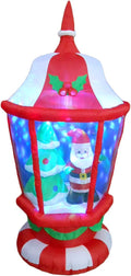 Red and white lantern inflatable with Santa and a tree inside glowing with color