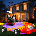 Grim reaper driving a purple hot rod with orange flames inflatable in front of a house at night
