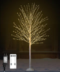 White birch tree densely lit with warm white LEDs, with a remote and adapter