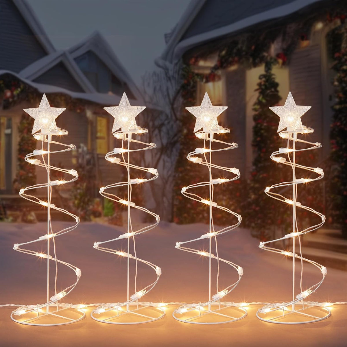 Four warm white spiral Christmas tree lights with star toppers in a row