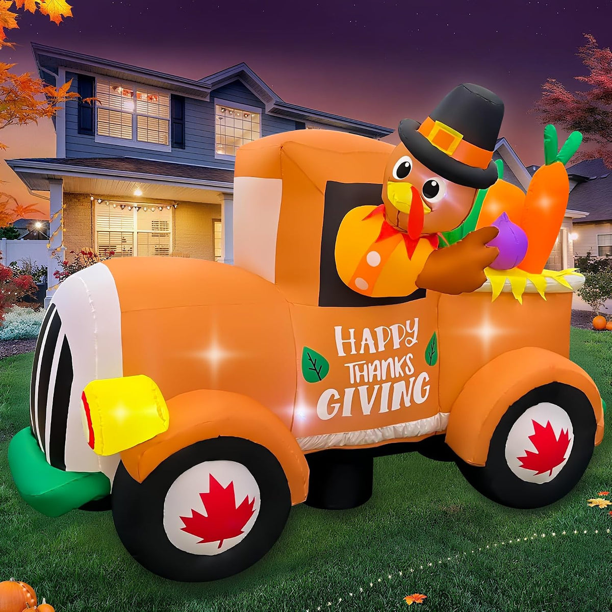 Turkey in a pilgrim hat driving an orange Happy Thanksgiving pickup inflatable on a lawn