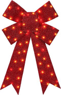 Large glittery red Christmas bow with warm LED lights