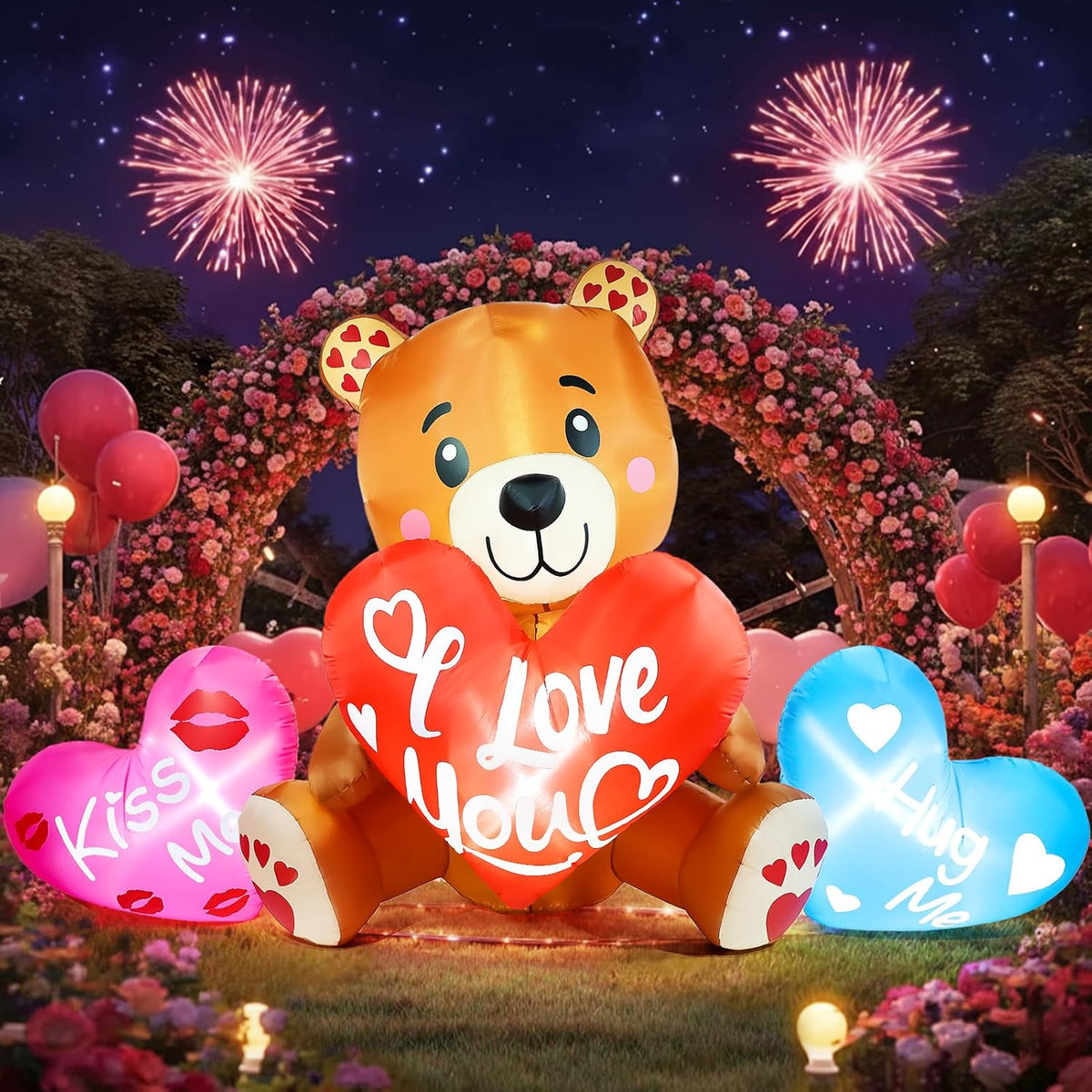 Teddy bear inflatable holding a red I Love You heart with message hearts beside it under fireworks