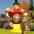 Tall turkey inflatable in a pilgrim hat holding a pie beside a Happy Thanksgiving sign and a family